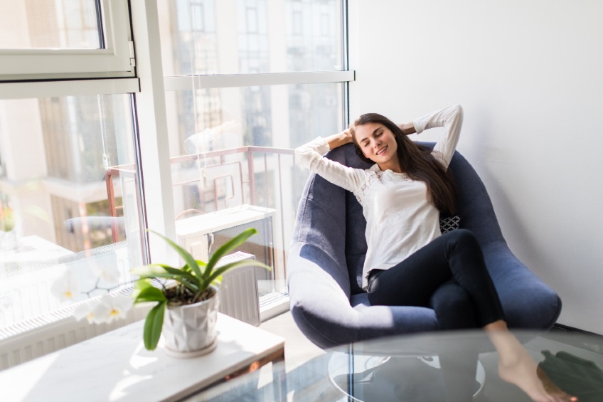 woman relaxing by a window with solar window film